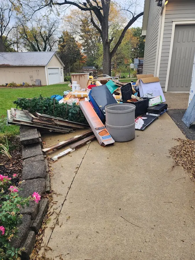 Dumpster being loaded with debris for 12 Yard Dumpster Rental in Wendell